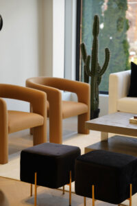 Luxury living space Toronto with modern lounge chairs and soft neutral interior palette