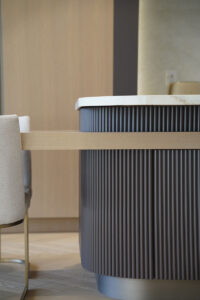 Custom millwork island Toronto with fluted wood cabinetry and rounded countertop detail