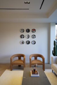 Luxury living space Toronto with lounge chairs and minimalist wall art composition
