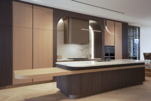 Modern custom kitchen Toronto with large island, arch detail, and integrated cabinetry