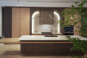 Modern custom kitchen Toronto with large island, arch detail, and integrated cabinetry