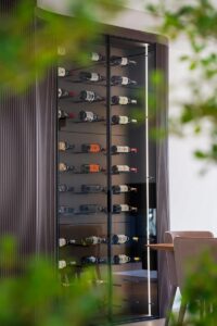 Built-in wine display Toronto with glass enclosure and custom storage system