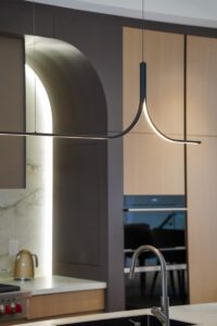Modern kitchen lighting Toronto with sculptural pendant and architectural arch detail
